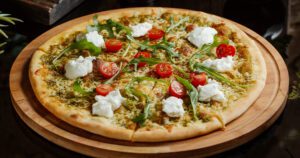 pesto pizza with cherry tomatoes and mozzarella greenstreet Gardens